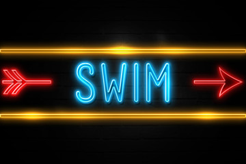 Swim  - fluorescent Neon Sign on brickwall Front view