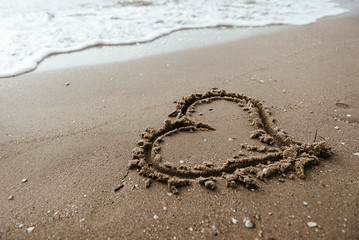 Heart on the sand beach. Conceptual love