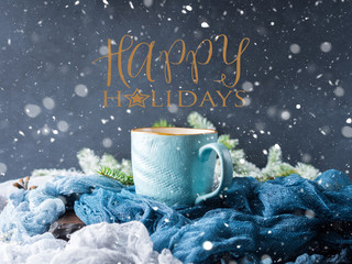 Mug of coffee and milk on dark blue winter background. Hot drink still life. Wishing happy holidays greeting card