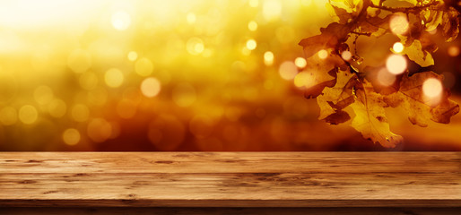 Autumn leaves background with wooden table