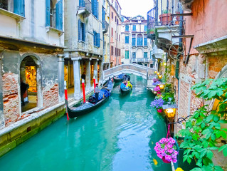 Classical picture of the venetian canals with boats across canal - obrazy, fototapety, plakaty