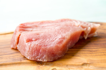 A fresh piece of tuna on a wooden board