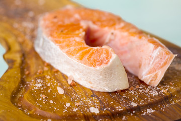 fresh salmon steaks on a wooden board