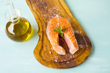 fresh salmon steaks on a wooden board