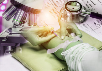 Double exposure nurse pricking needle syringe in the arm patient drawing blood sample for blood...