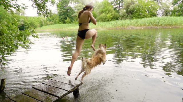 Collie dog with young girl dive into the river