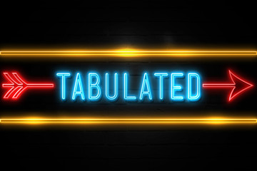 Tabulated  - fluorescent Neon Sign on brickwall Front view