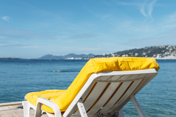 Empty yellow beach lounge overlooking the Mediterranean Sea in Juan les Pins, France