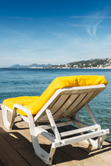 Empty yellow beach lounge overlooking the Mediterranean Sea in Juan les Pins, France