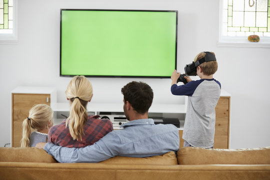 Family Playing Computer Game Using Virtual Reality Headset