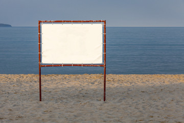 White billboard on a background of blue sea and sky