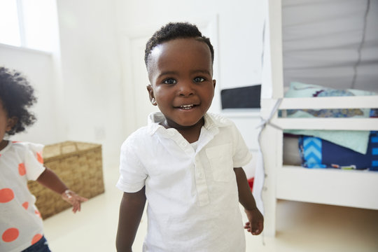 Portrait Of Smiling Young Boy Standing In Playroom