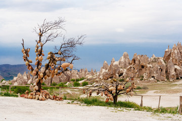 Pottery is hanging on a tree on the roadside in Goreme. Cappadocia