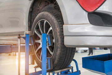    Car on lift to repair suspension in the garage to change motor oil and maintenance repair at...