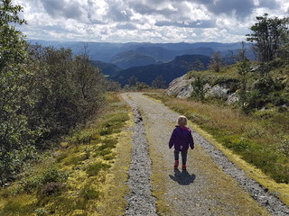 Child hiking in Norwegian mountains