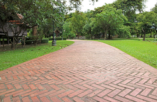 Terracotta Brick Paver Walkway in the Vibrant Green Garden in Thailand 