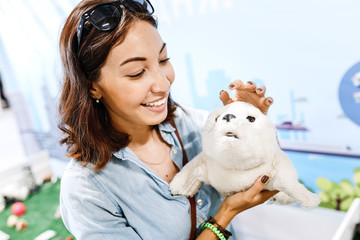 Woman play with therapeutic robotic cute pet toy for disabled people
