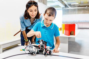 Mother and son are studying robotics and modern electronics at an educational exhibition