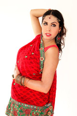 Woman dancing Indian dance in national dress. A handsome beautiful girl portrait in red Hindu...