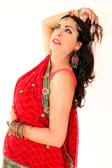 Woman dancing Indian dance in national dress. A handsome beautiful girl portrait in red Hindu...