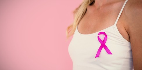 Mid section of young woman supporting breast cancer awareness