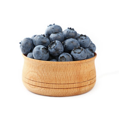 Blueberries in wooden bowl close up over white