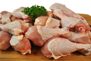 Raw Chicken Legs on a Cutting Board with Parsley