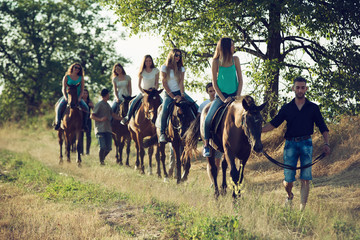 Friends Horseback Riding in the Countryside