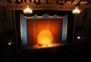 Broadway stage with spotlight and curtain