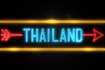 Thailand  - fluorescent Neon Sign on brickwall Front view