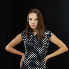 The girl is dressed in a polka-dot dress