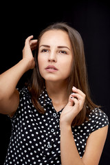 The girl is dressed in a polka-dot dress