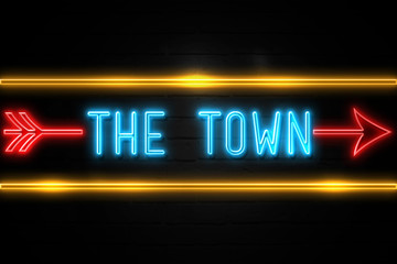 Obraz premium The Town - fluorescent Neon Sign on brickwall Front view