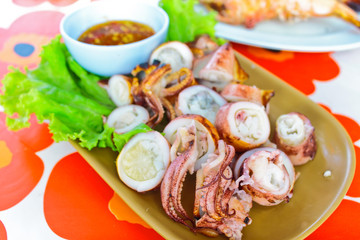 Chopped grill cuttlefish serve with chili-sauce and salad