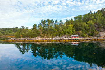 Fototapeta na wymiar Traditional red fishing rorbu hut near Alesund in Norway