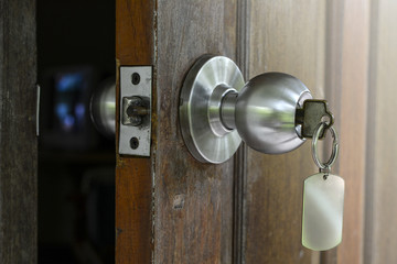 The net mOpened Wooden door with key to houseetal and padlock