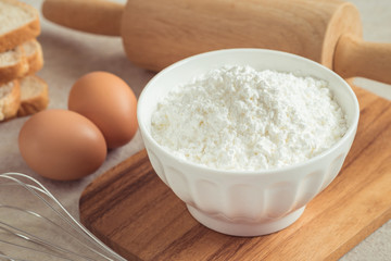 Flour in bowl with eggs and bread