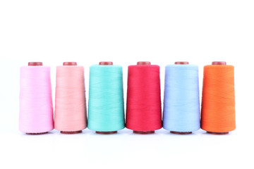Colorful Sewing threads isolated on white background