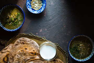 Mung bean soup and chapatti on the dark background