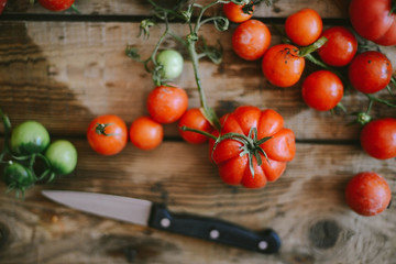 Fresh cherry tomatoes on rustic wooden table, Top view with copy space.