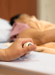 Closed up of women hand pressing emergency nurse call button,selective focus
