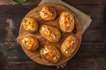 Baked potatoes with cheese, bacon, and copy space