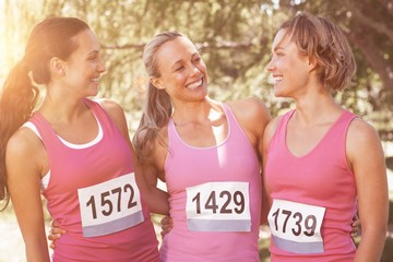 Smiling women running for breast cancer awareness