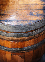 Old wooden Barrel close up. Natural grunge textured barrel. Dark surface with old natural wooden...