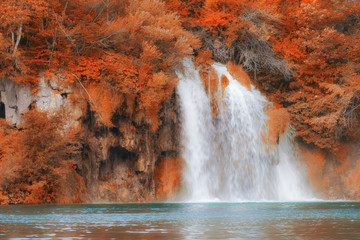 Fototapeta na wymiar Beautiful fall colors forest waterfall and lake