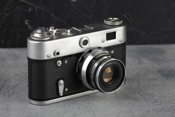 The old rangefinder camera on cement background.