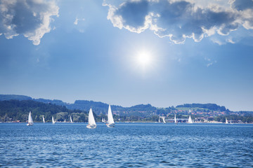 Yacht regatta on the lake at sunny day