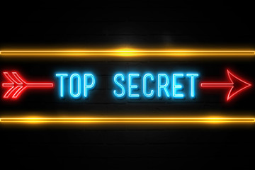 Fototapeta premium Top Secret - fluorescent Neon Sign on brickwall Front view