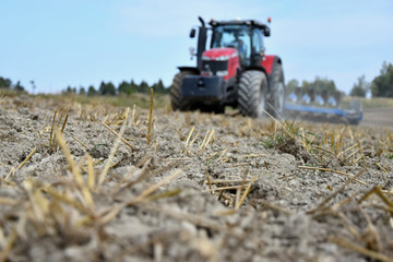 Tractor plowing a field. Preparation of the field after the season before winter.