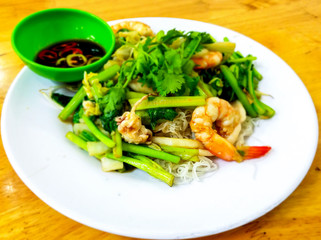 Stir fired rice noodles with seafood.